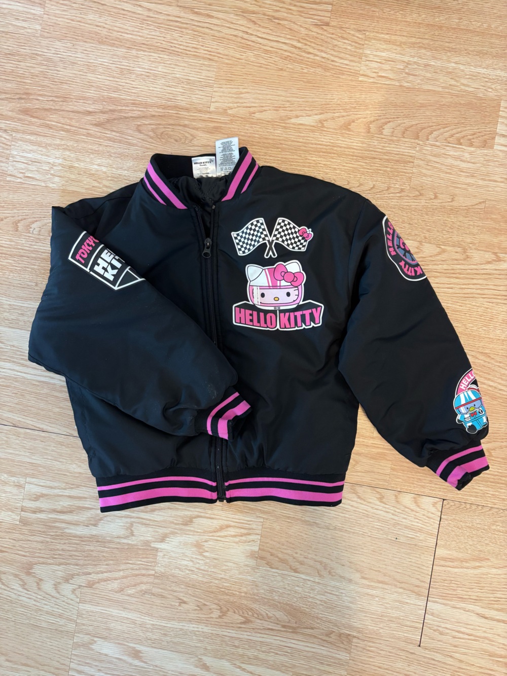 Girls Hello Kitty Black and Pink Racing Patch Bomber